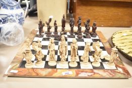 An attractive marble and onyx based chess set having onyx detailing to border, consisting of