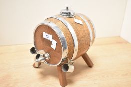 An early 20th-century Nelcraft of Nottingham chromium plated and wooden barrel decanter set, with