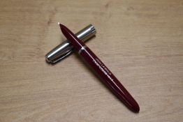 A boxed Parker 21 aerometric fill fountain pen and pencil in Red with stainless steel cap. Circa