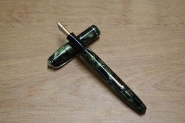 A Conway Stewart 75 lever fill fountain pen in Green and Black Marble with single narrow cap band