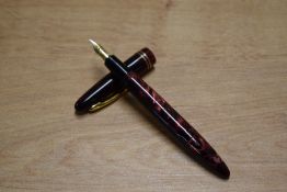 A Meteore 927 button fill fountain pen in Red Marble with two narrow cap bands having Stabilior 15