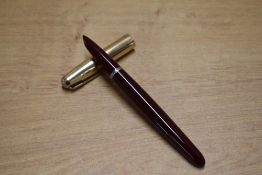 A boxed Parker 51 aerometric fill fountain pen in Burgundy with Gold fill converging line cap. Circa