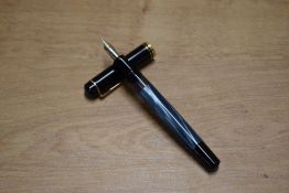 A Pelikan M200 piston fill fountain pen in Blue Marble with broad and narrow ca band having