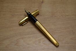 A Parker 75 Insignia converter fill fountain pen in Gold Plate having Parker 585 France 14K nib