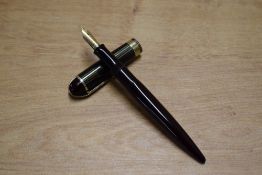 A Wahl Eversharp Skyline lever fill fountain pen in Plum with striped Green and Black cap with