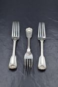 A group of three Victorian silver fiddle and shell pattern forks, having dog heraldic crests to