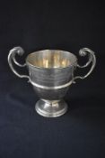 A Victorian silver trophy, of traditional form having a moulded rim with scroll handles and