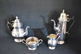 An Elizabeth II silver four piece tea set, comprising coffee, tea, sugar and cream, of circular