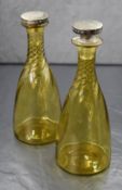 A pair of Victorian silver mounted hand blown glass decanters, having twisted necks with silver