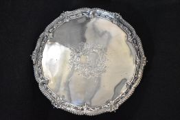 A Victorian silver salver, of circular form having a gadrooned and scroll rim with a central