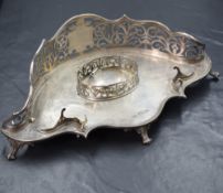 A late Victorian silver desk ink and pen stand, of lobed form having a pierced scroll side with a
