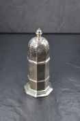 An early 20th century silver sugar caster, the canted finial over the pierced top, having a canted
