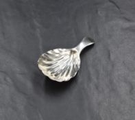 A Georgian silver caddy spoon, having a scalloped bowl, rubbed hallmarks, maker William Sumner &