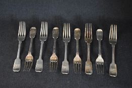 A group of nine William IV silver fiddle pattern forks, having heraldic crests to terminals, marks