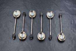 A cased set of six George V silver coffee bean spoons, of traditional form having black 'coffee