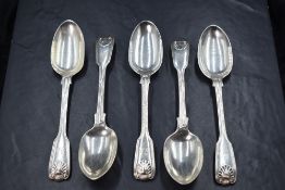A group of five Victorian silver fiddle and shell pattern dessert spoons, having dog heraldic crests