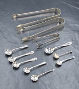 An assortment of eight silver condiment spoons, along with three pairs of silver and white metal