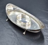 An Edwardian silver desk stand, of elliptical form having pierced walls with a central oval stand