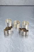 A pair of Victorian silver napkin rings, of lobed form with decorative floral scroll engraving,