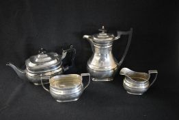 A George V silver four piece tea set, comprising coffee, tea, sugar and cream, of bulbous oval