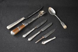 A silver plated wooden handled stilton cheese scoop, of traditional form with a sliding pusher