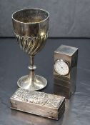 An Edwardian silver ring box, of hinged rectangular form having embossed scroll decoration with a