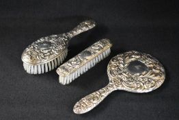A new in box Elizabeth II silver mounted vanity set, comprising a hand mirror, hair brush, comb