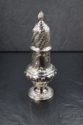 A Victorian silver sugar caster, the spiral finial over the pierced top, having a bulbous body
