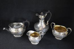 A late George III silver four piece tea set, comprising tea, coffee, sugar and cream, of bulbous