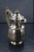 A George V silver coffee pot, of circular form having a Chippendale style rim with scroll handle,