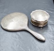 A George V silver mounted hand mirror, having engine turned decoration and a central vacant circular