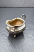 A late Victorian silver cream jug, of rectangular form having a gadrooned rim, generous spout