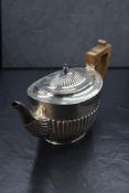 A Victorian silver teapot, of oval form having a half gadrooned body and angular handle, marks for