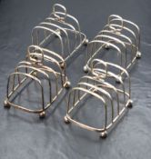 A set of four George V silver toast racks, of rectangular form having four ball feet, marks for