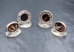 Four cased George V silver and tortoiseshell menu holders, two of circular form having a pierced