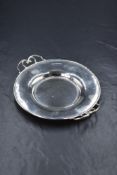 An Edwardian silver dish, having a moulded rim with pierced scroll handles, marks for Sheffield