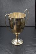 A George V silver trophy of traditional form, having scroll handles and personalised engraving '