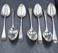 A group of seven George III silver Old English pattern serving spoons, four having 'P' initial and