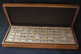 A wooden cased set of fifty silver ingots of '1000 Years of British Monarchy Sterling Silver Mint