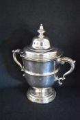 An impressive Victorian silver lidded trophy, of traditional form having a finial top over a moulded