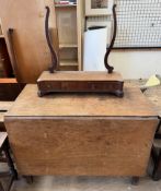 A 19th century mahogany gateleg dining table with a rectangular top and drop flaps together with a