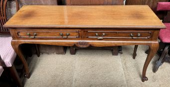 A 20th century mahogany sideboard with a rectangular top and two drawers on cabriole legs and peg
