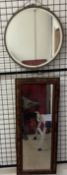 A faux walnut framed wall mirror together with a circular wall mirror