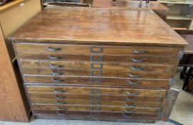An oak ten drawer plan chest of rectangular form on a plinth,