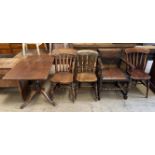 A 19th century mahogany tripod table with a rectangular top on a turned column and three legs
