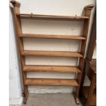 A set of pine hanging shelves, on shaped base,