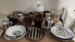 A studio pottery vase together with copper lustre jugs, pottery plates, table lamp,