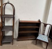 A mahogany bookcase together with a three tier caned whatnot and a nursing chair
