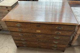 An oak plan chest, with a rectangular top above six long drawers,
