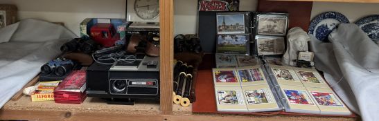 Two albums of Royal Mail postcards together with other postcards, projector, binoculars,